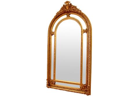 A dignified French Transitional Louis XV Rococo style grand floor gilt-wood mirror, The fine carved double frame hand carved and gilded with French gold foils and patinated, surmounted with a royal cavetto cartouche flanked by an enchanting acanthus spinosus spray wreath, The convex outer frame is craved with pearls and egg and dart motif continued with a concave extension carved with rinceau style and bordered again with pearls, The sectional mirror plate with another frame shaped in Ovolo with egg-and-dart and scattered on outer section different cartouches on corners, center and top, The frame terminates on both sides with scrolled Rocaille motifs.